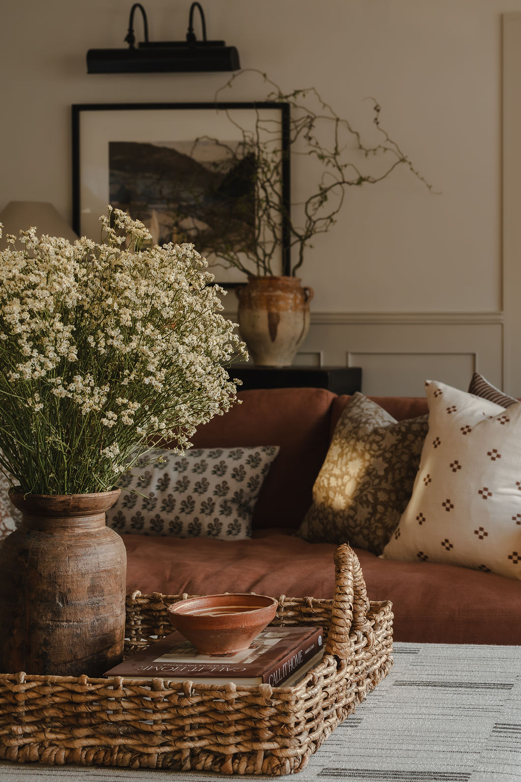 Living room with layered cushions and warm light